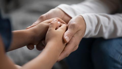 Two people holding hands